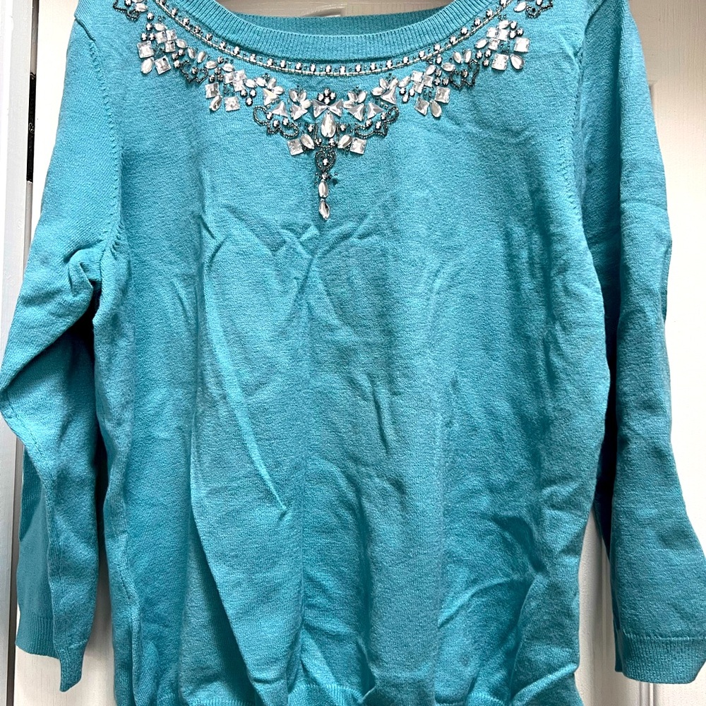 Sparkling teal sweater! Beautiful rhinestones. All intact. Never been worn.